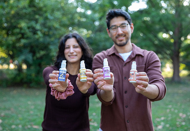 Jess and Marc Outside holding 4 Moops bottles