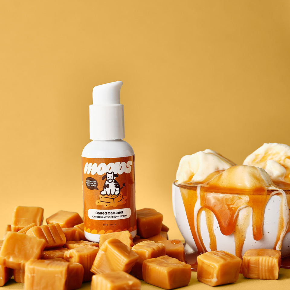 Salted caramel Moops bottle next to caramel squares and ice cream with caramel on it.